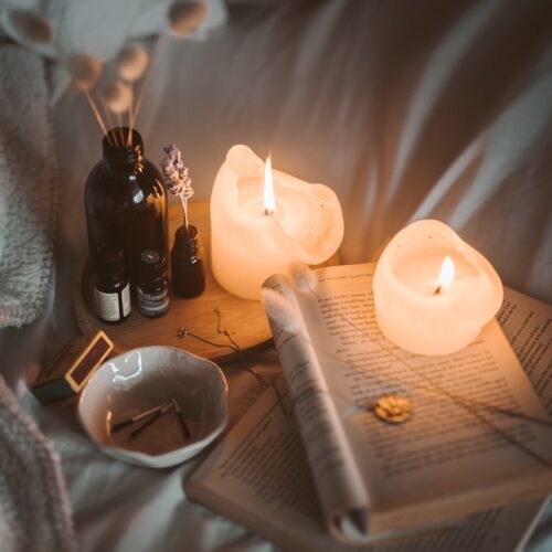 relaxing self care with book and candles for motherhood wellness