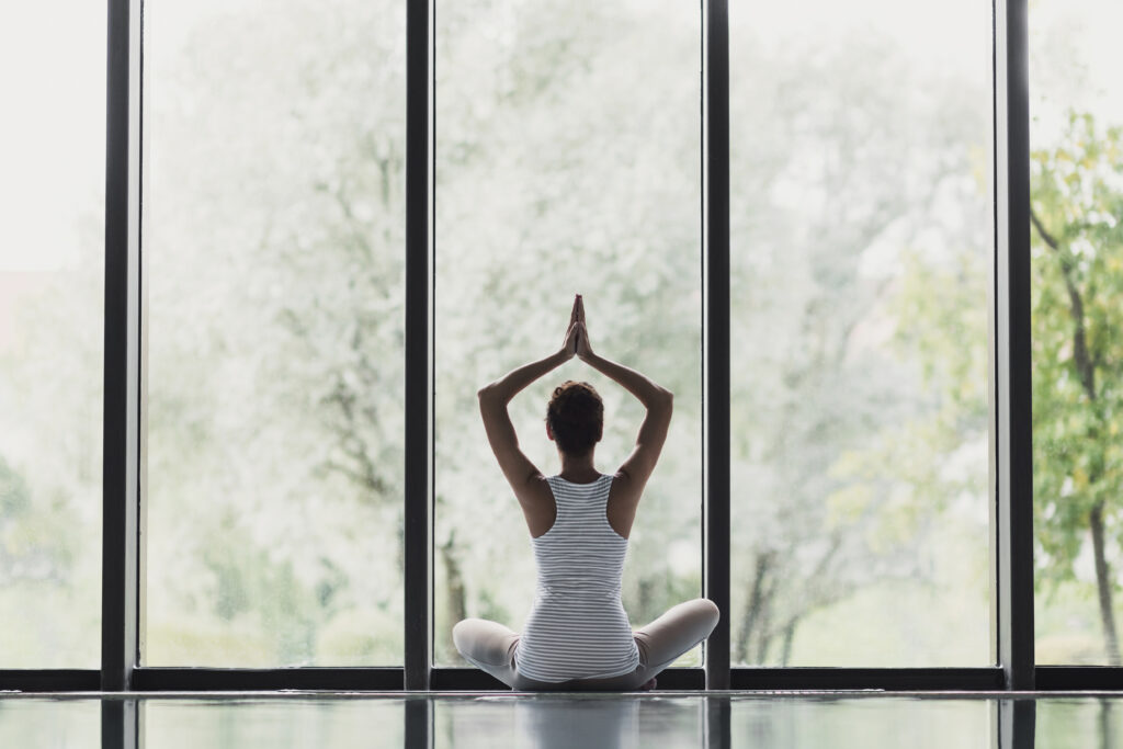 Woman doing yoga to balance self-care
