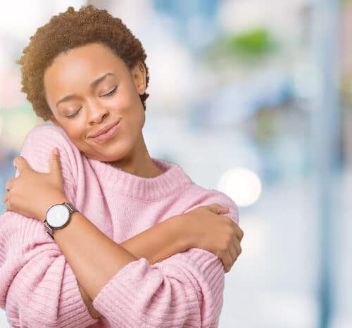 Woman hugging herself