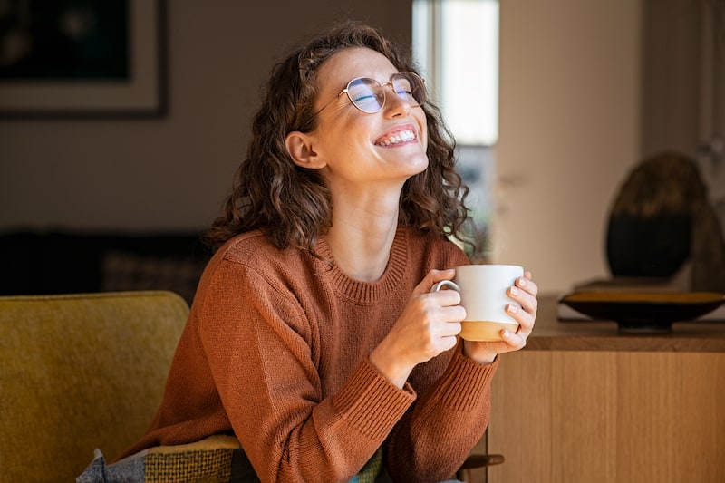 woman enjoying cup of coffee as an example of self care as a busy mom
