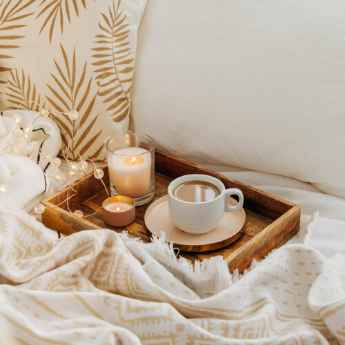 Wooden tray with coffee and candles