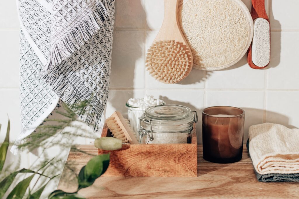brown wooden chopping board beside clear glass jar as example of self care kit idea