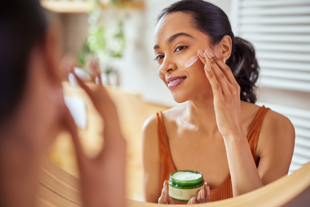 woman putting on face cream exploring beauty & ritual