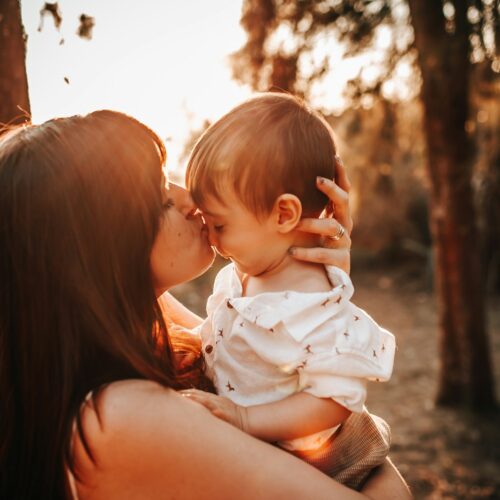 emotional landscape of postpartum - woman carrying baby during daytime